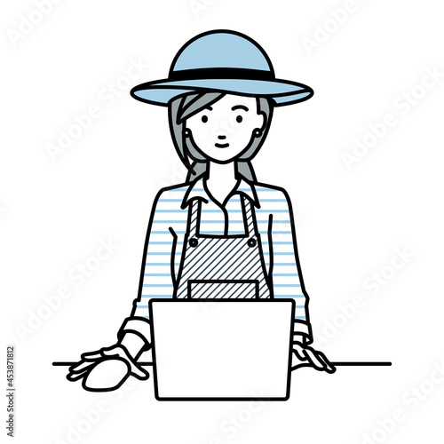 デスクで座ってPCを使っている農家の女性