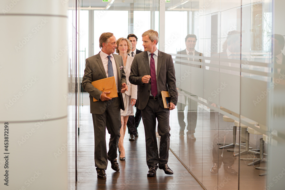 Business people talking in office lobby Business people talking in office lobby