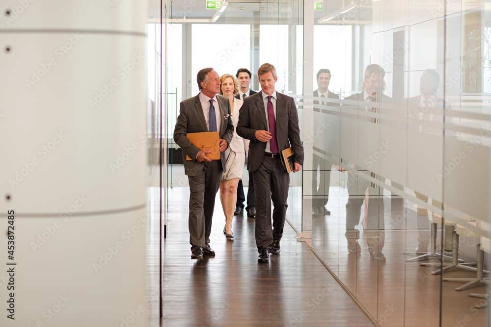 Business people talking in office lobby