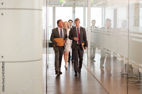 Business people talking in office lobby