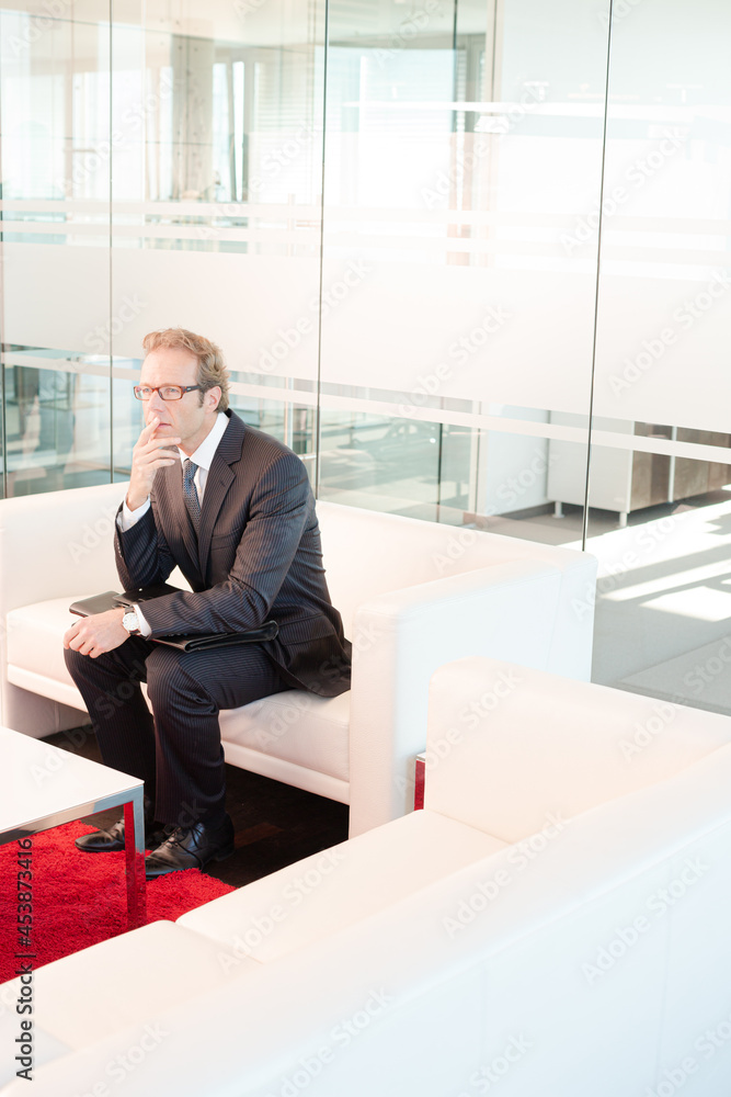 Fototapeta premium Businessman standing in office hallway