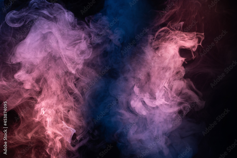 Fototapeta premium Blue and pink steam on a black background.