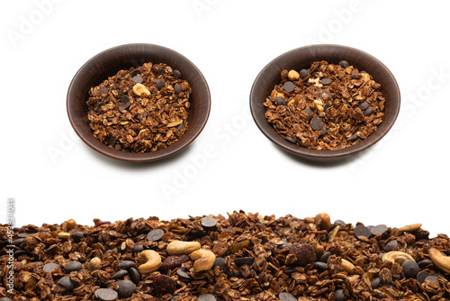 Chocolate granola cereal with nuts background.