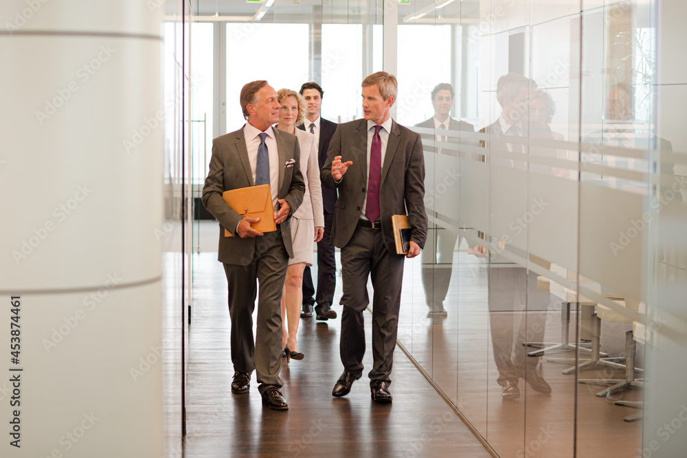 Business people talking in office lobby