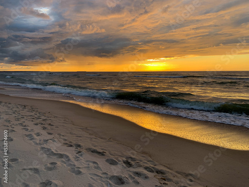 Peaceful sunset at the sea  sand beach  yellow orange sunset