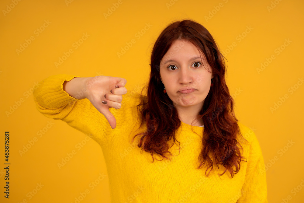 Young woman showing thumbs down. Young woman showing thumbs down.