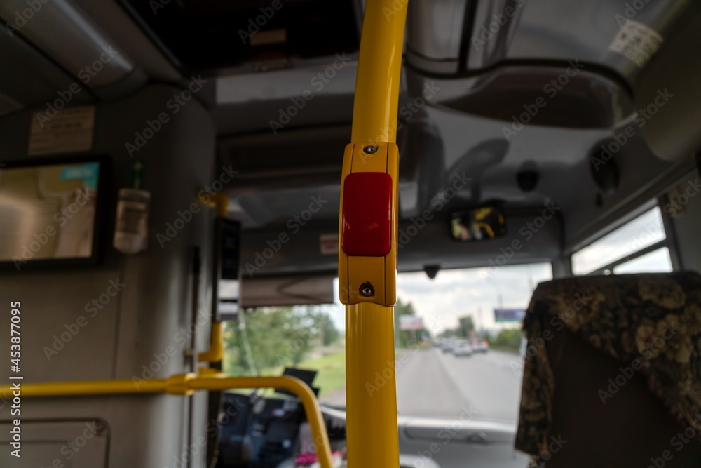 Button for communication with the driver on the handrail stand in the passenger compartment of the city public bus. Button for communication with the driver on the handrail stand in the passenger compartment of the city public bus.