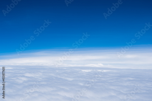 Aerial view scene of the white fluffy clouds and blue bright sky background