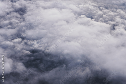 Aerial view scene of the white fluffy clouds cover fully the land