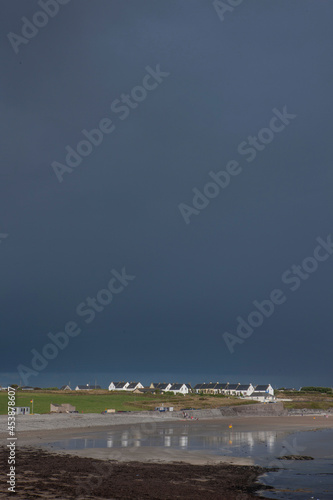 Dark rain clouds comming up at Garretstown  South west Ireland. Coast. Ocean. photo