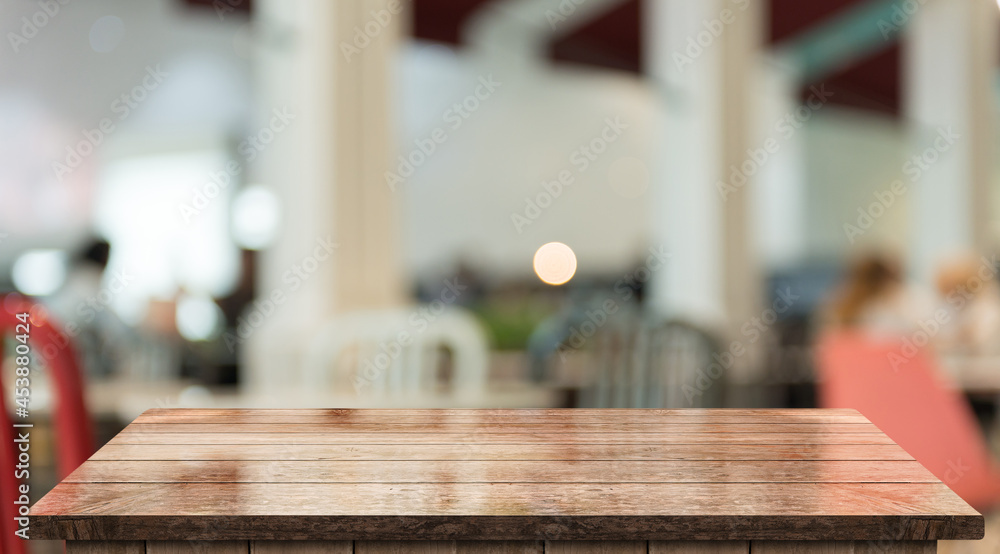 Empty wooden table top with lights bokeh on blur restaurant background. Empty wooden table top with lights bokeh on blur restaurant background.