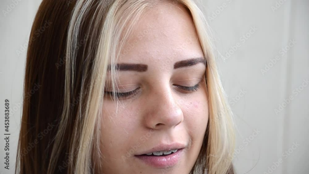 Pretty caucasian young girl sings with her eyes closed. Brunette teen girl in dental braces. Teenage concept. Tooth alignment with braces. Young woman sings with pleasure. Pretty caucasian young girl sings with her eyes closed. Brunette teen girl in dental braces. Teenage concept. Tooth alignment with braces. Young woman sings with pleasure.