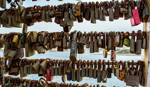 Bunch of rusty love locks hanging on the bridge in Sliema, Malta.