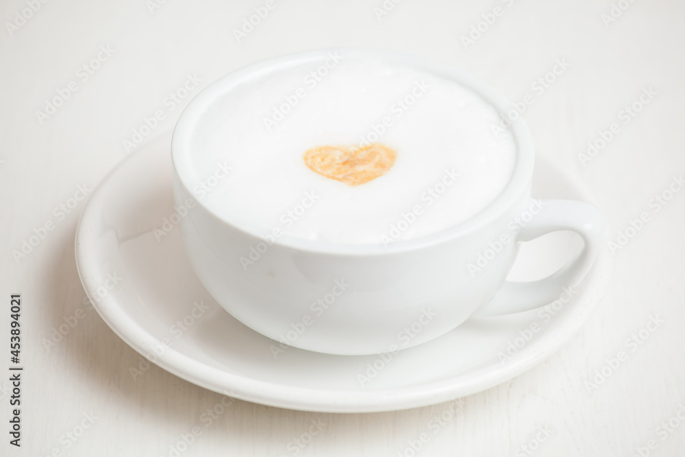 cup of cappuccino with heart foam art cup of cappuccino with heart foam art