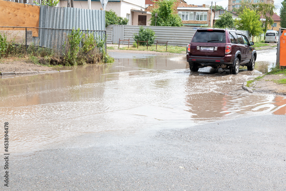 after a long shower, the whole street is flooded after a long shower, the whole street is flooded