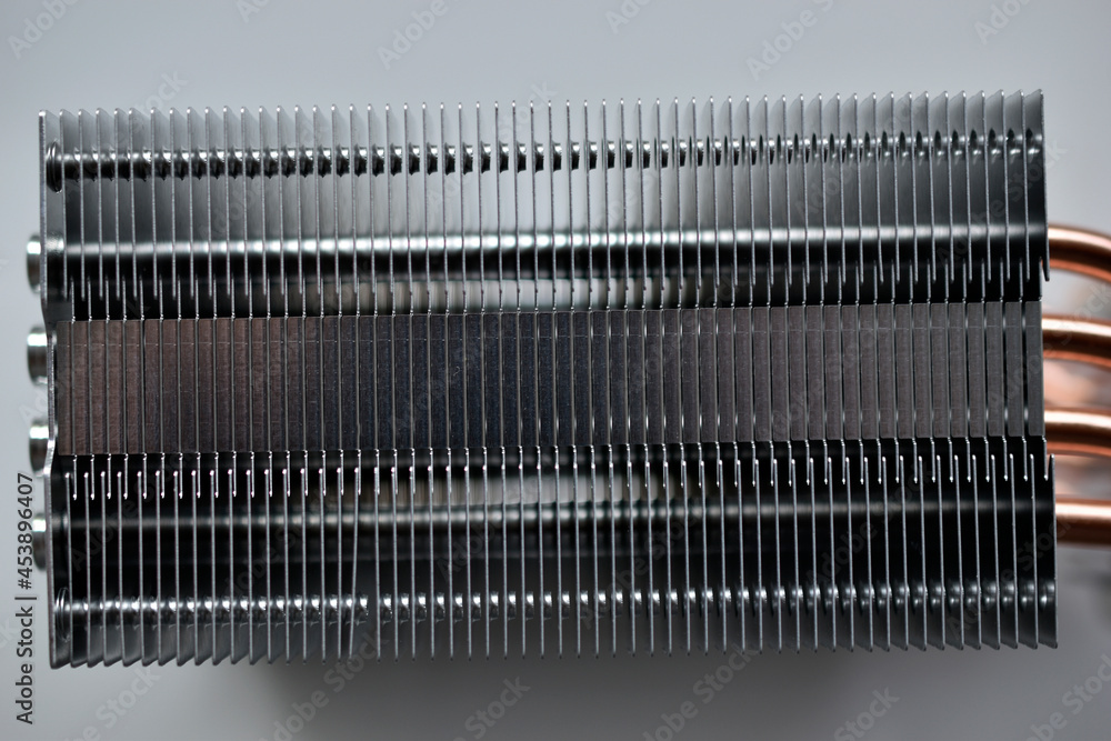 Silver aluminum CPU radiator with copper cooling tubes close-up Silver aluminum CPU radiator with copper cooling tubes close-up