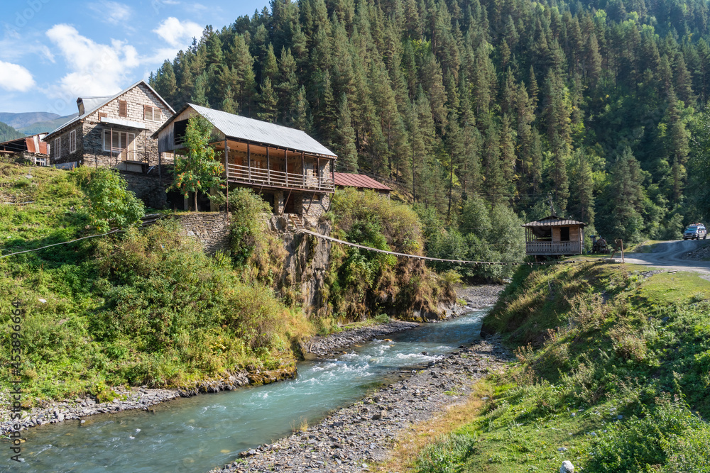 Hanging bridge on a mountain river in the village. Tusheti. Georiga Hanging bridge on a mountain river in the village. Tusheti. Georiga