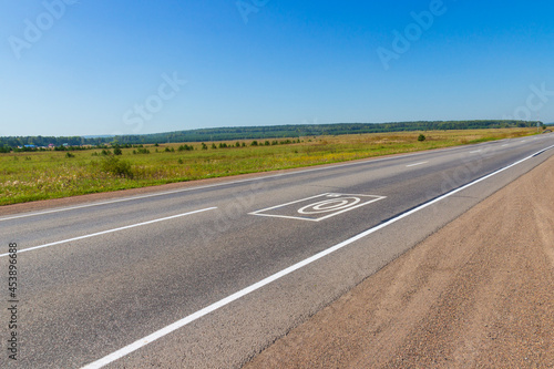 Summer landscape with rural road. Photo and video recording markings on the asphalt warns about the complex for automatic recording of offenses on the road by drivers © Вера Тихонова