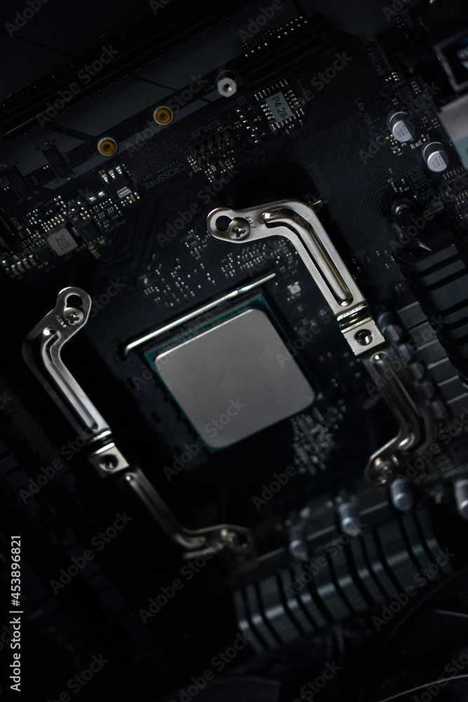 Fototapeta premium Silver computer processor on a black motherboard