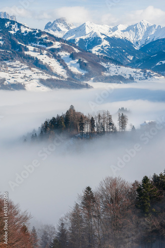 Snowy mountain landscape above the sea of fog, Switzerland, Alps