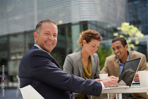 Businessman smiling in meeting outdoors