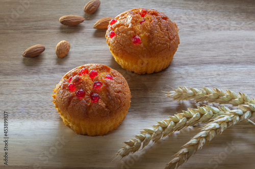 Gluten free almond flour cupcake, muffins with raspberries. Copy space, light wooden background photo