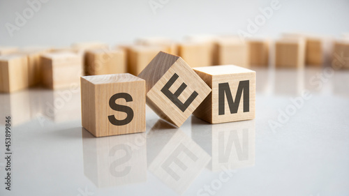 SEM - Search Engine Marketing acronym concept on cubes, gray background