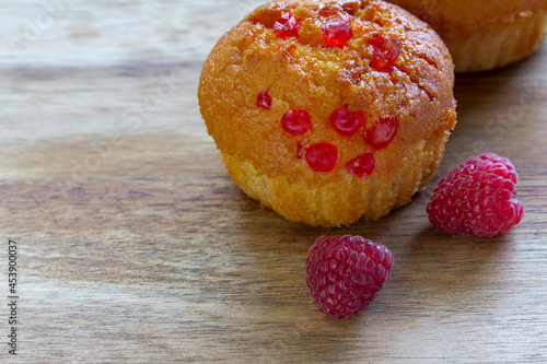 Gluten free almond flour cupcake, muffins with raspberries. Copy space, light wooden background photo