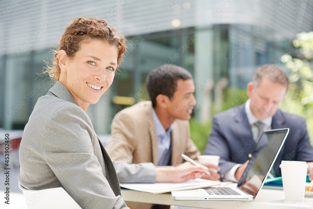 Fototapeta premium Businesswoman smiling in meeting outdoors
