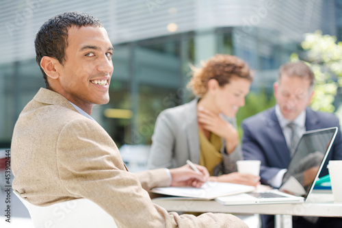 Businessman smiling in meeting outdoors