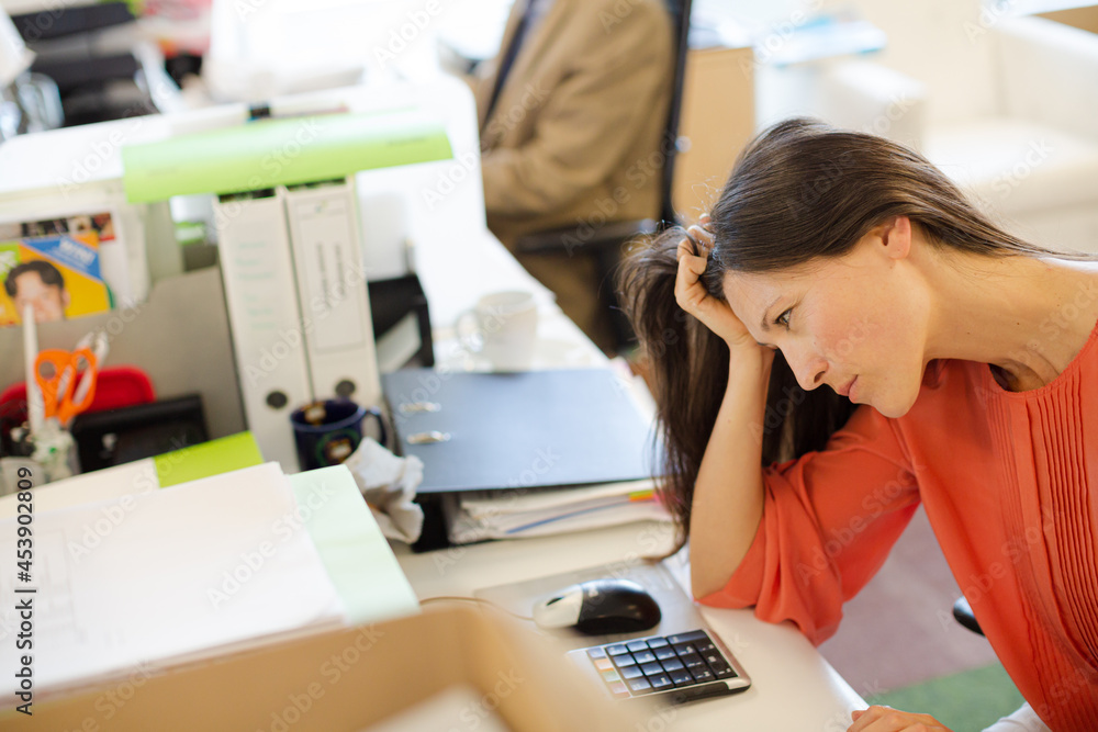 Businesswoman thinking at desk Businesswoman thinking at desk