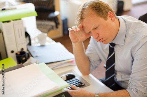 Принти на полотні Businessman sighing at desk