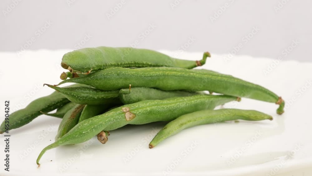 Shot of green beans isolated over white surface Shot of green beans isolated over white surface