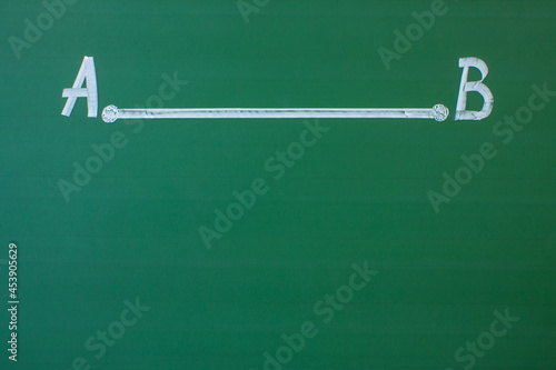 Obraz na płótnie A straight segment with two points A and B drawn in white chalk on a green blackboard close-up and space for copying w salonie
