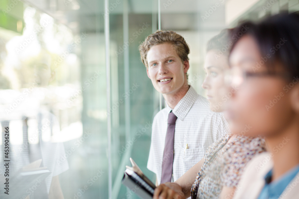 Fototapeta premium Business people looking out office window