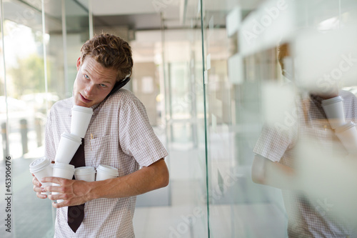 Businesswoman balancing coffee cups in office