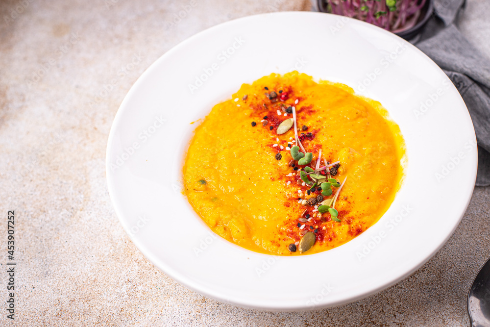 pumpkin cream soup puree fresh portion ready to eat meal snack on the table copy space food background rustic. top view keto or paleo diet veggie vegan or vegetarian food pumpkin cream soup puree fresh portion ready to eat meal snack on the table copy space food background rustic. top view keto or paleo diet veggie vegan or vegetarian food