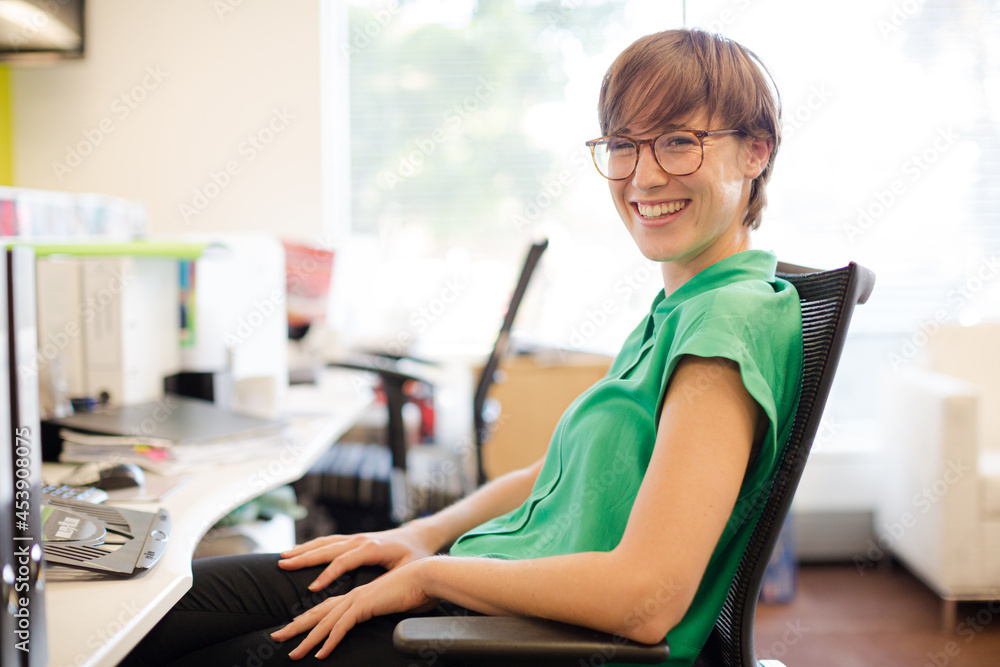 Businesswoman smiling at desk Businesswoman smiling at desk