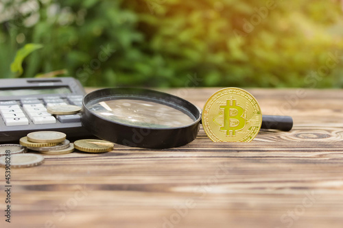 Calculator, physical bitcoin, money in euros. Business concept