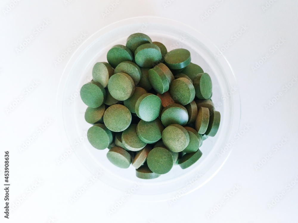 green pills on white background green pills on white background
