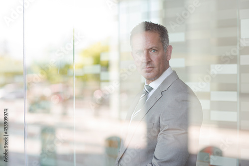 Businessman smiling at office window