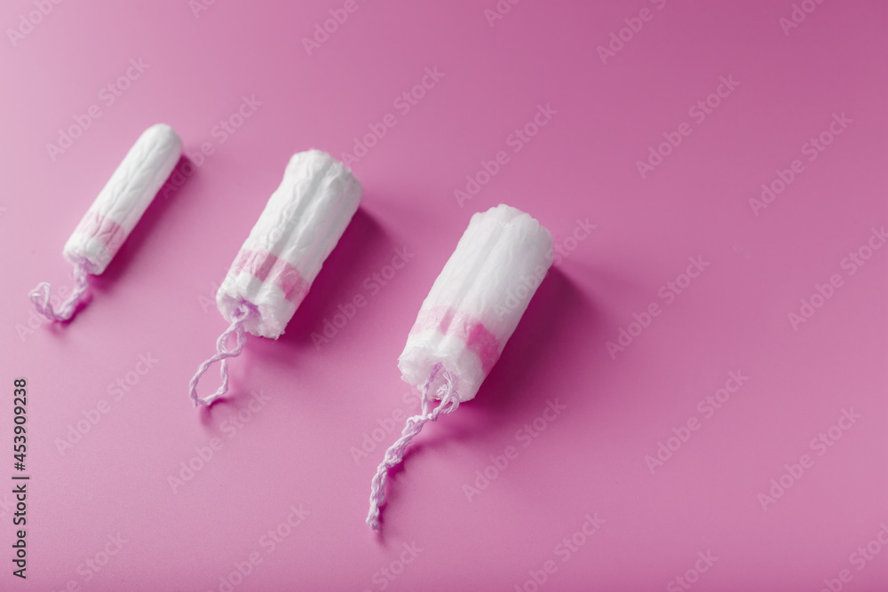 Gynecological tampons on a pink background free space Gynecological tampons on a pink background free space