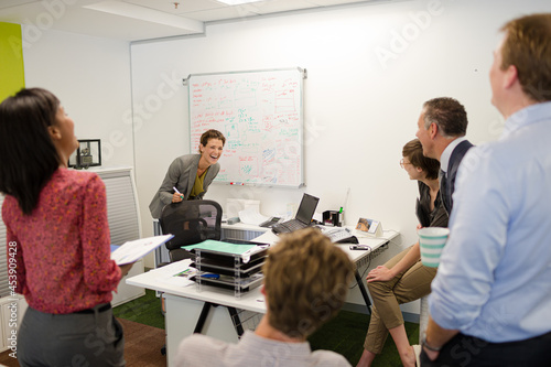 Businesswoman drawing on whiteboard in meeting