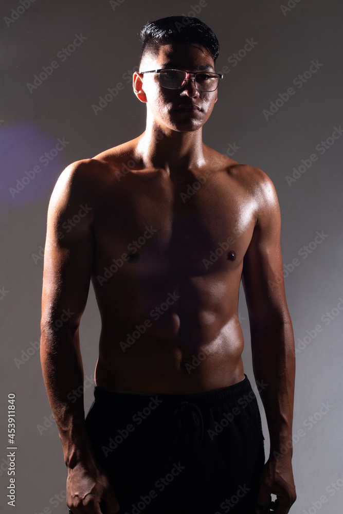 latin man posing on a dark background without a shirt. muscular man. fitness concept latin man posing on a dark background without a shirt. muscular man. fitness concept