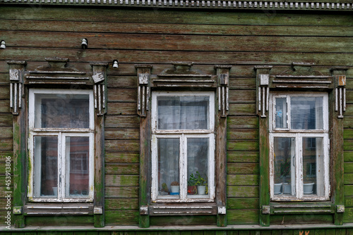 A windows in the wall of an old wooden house