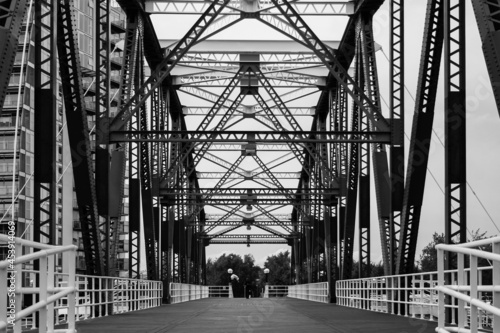 A black and white image of the view up the middle of the Detroit Swing Bridge in Salford Quays, Manchester.