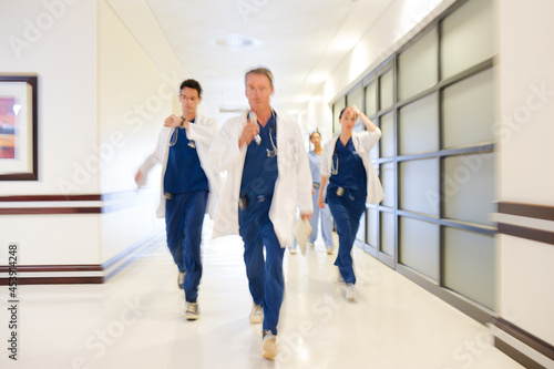 Doctors rushing down hospital corridor © KOTO