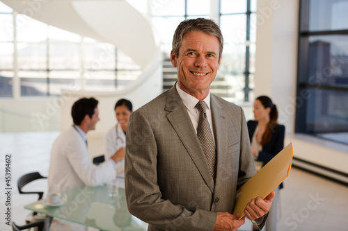 Doctor carrying folders in hospital