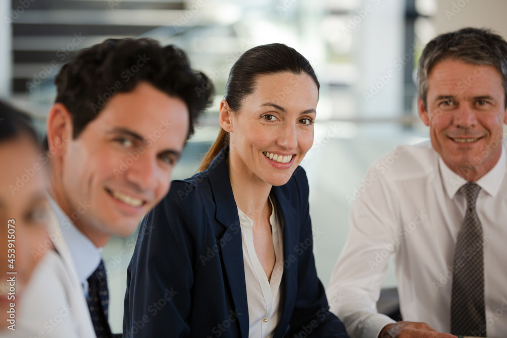 Portrait of smiling businesswoman and doctors in meeting Portrait of smiling businesswoman and doctors in meeting