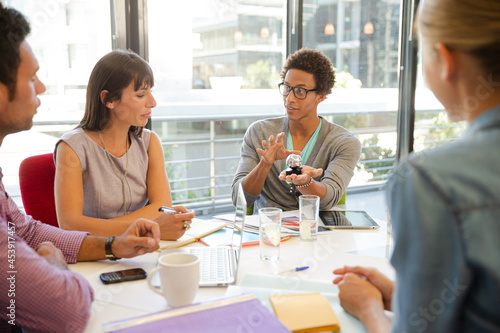 Business people examining model in meeting